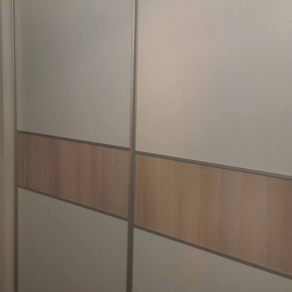 Armario de puertas correderas blanco con cenefa en roble